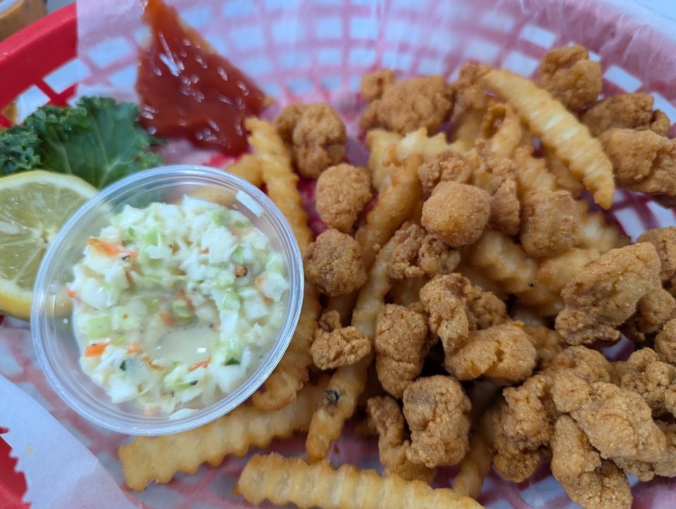 Fried fish served beside golden fries.
